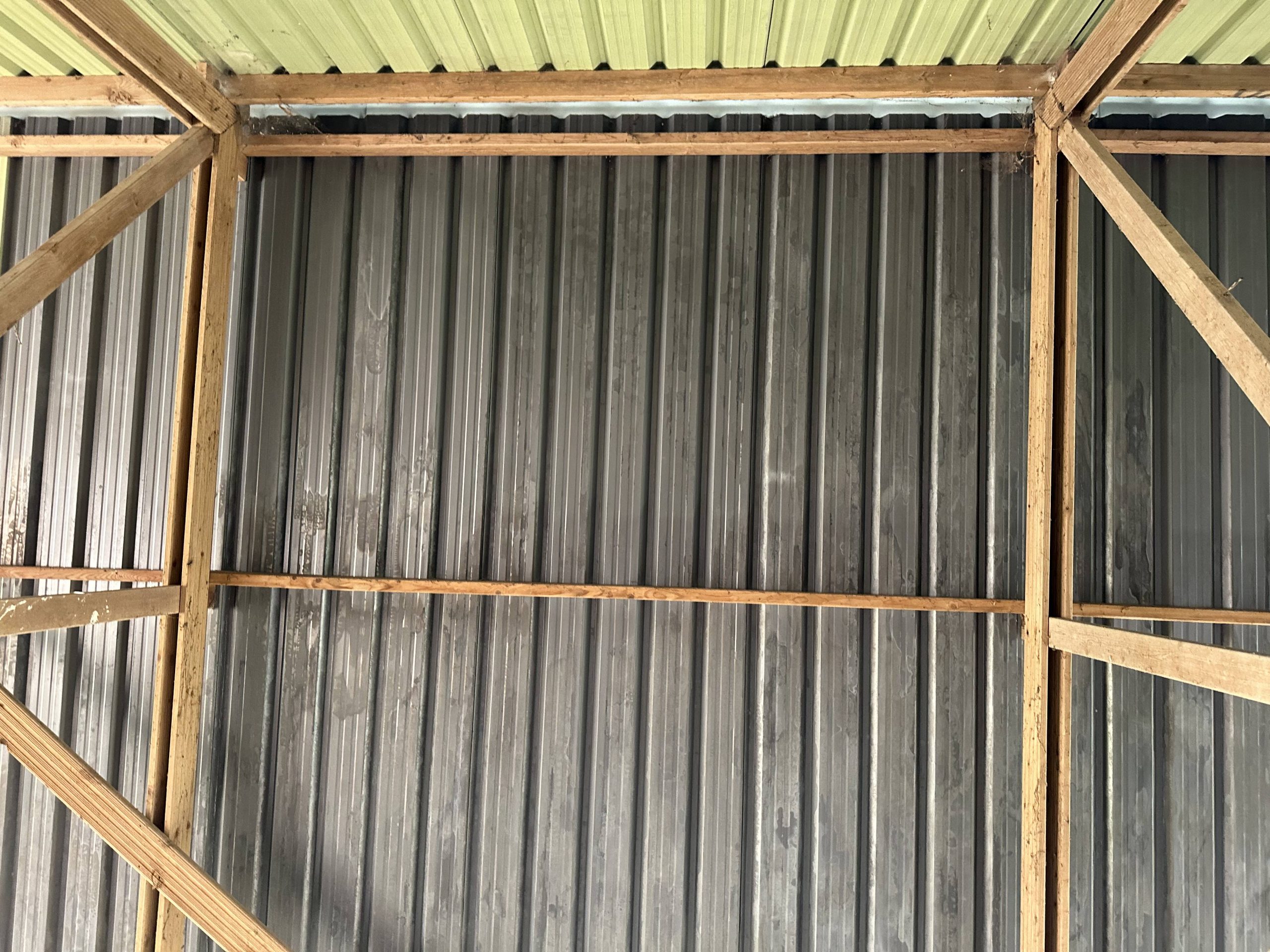Andrews Farm barn interior: abstract close-up of the corrugated metal roof panels and timber framing