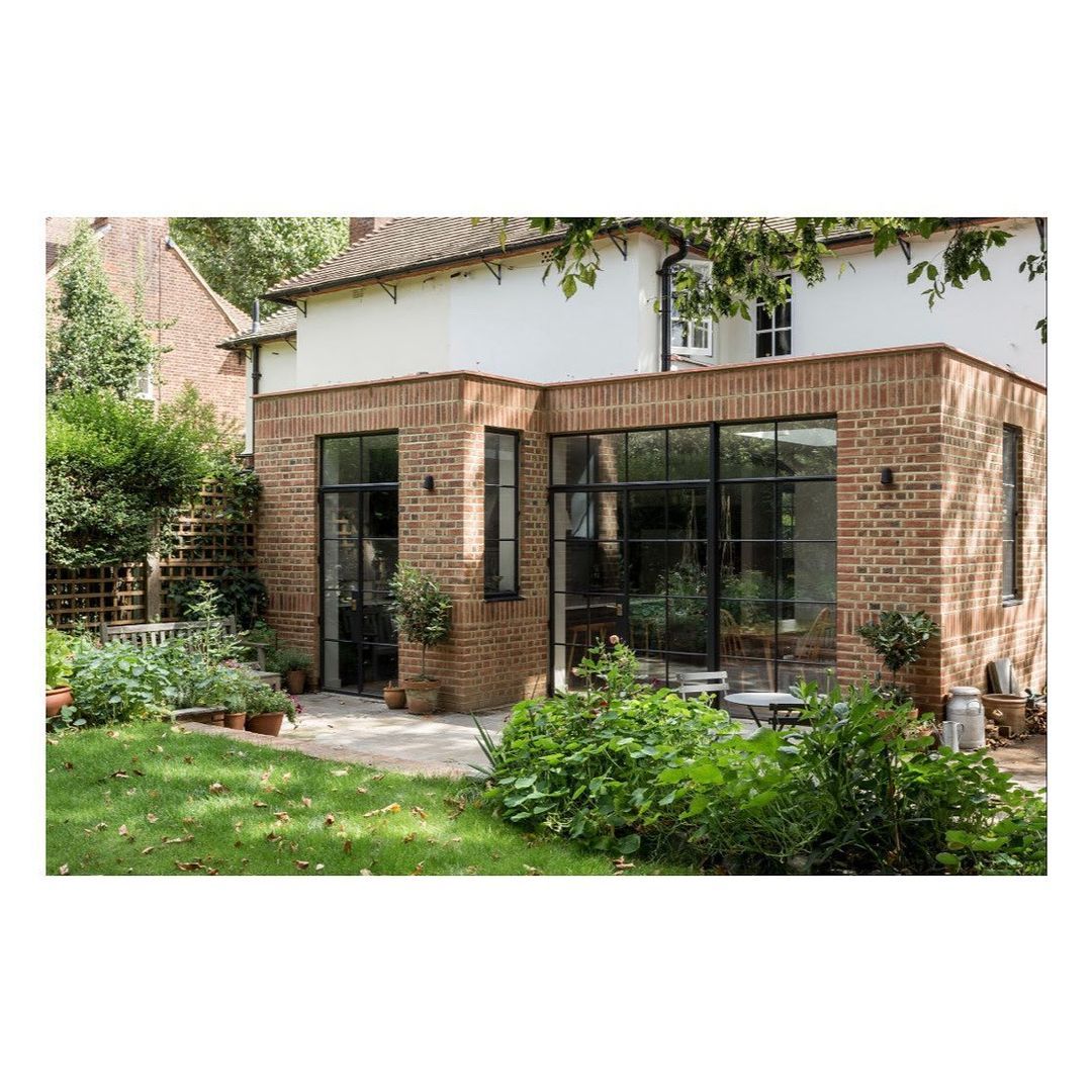 Wraparound extension in brick, slim steel-framed glazing. Billericay, Essex